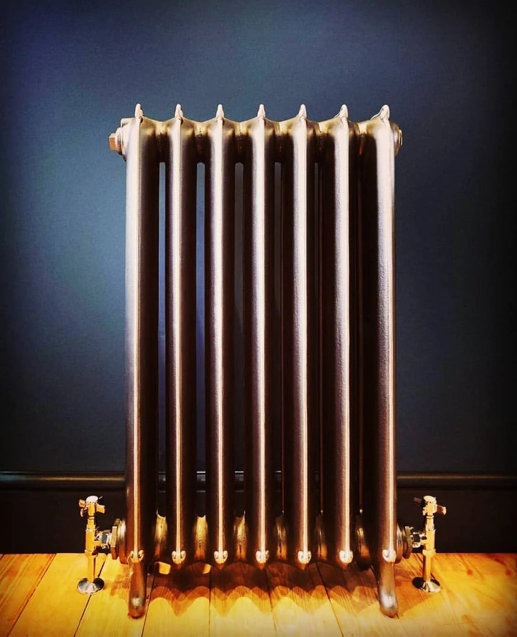 Cast iron radiator in a boldly coloured room